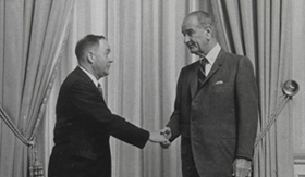 Picture of J. Francis Pohlhaus with Lyndon B. Johnson after signing 1964 Civil Rights Act shaking hands.