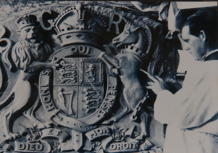 (DR) John Grant applying the finishing touches to the Royal Coat of Arms for the Preston Court House in Melbourne. Photo: Courtesy Dr Lachlan Grant