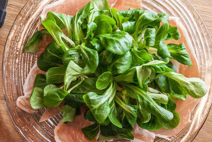 2. Rucola oder Nüsslisalat in Häufchen auf Fleisch anrichten