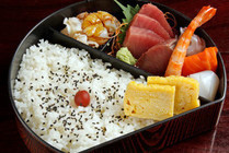 a lunch box fresh slices of raw fish