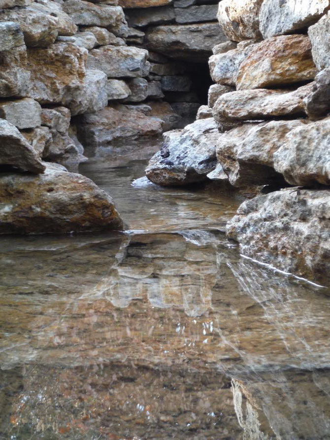 Mini stone canyon with stream flowing through it