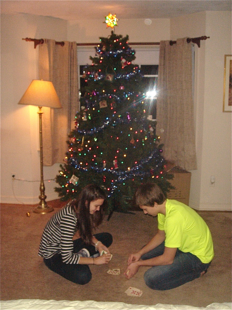 Ellie & Jack play cards in front of the Gudas Xmas tree in Syracuse.