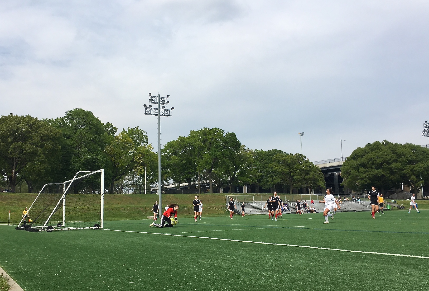 Kate  playing goalie, May 14, 2016 Randall's Island, in red jacket