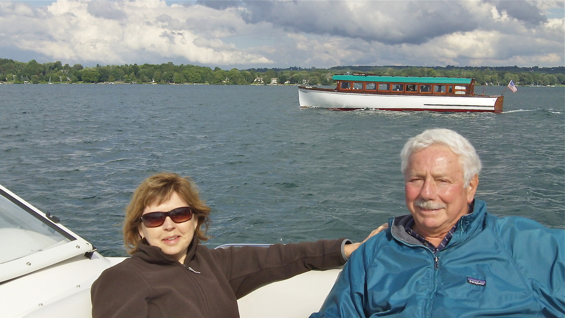 Barbara & Don, mailboat in the background, Skaneateles Lake