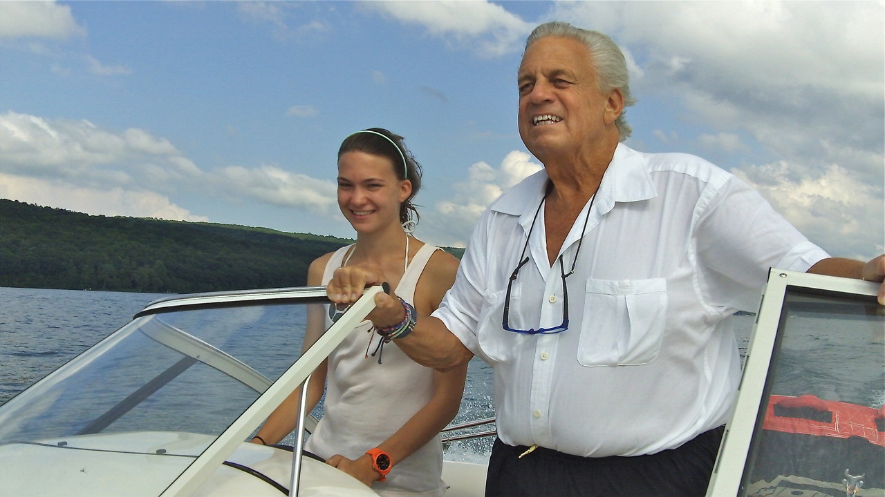 Ellie drives the speedboat under Stuart's guidance