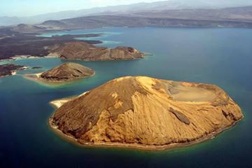 The Ghoubbet al-Kharab (  "the Gulf of the Demons") is a Djiboutian cove separated from the Gulf of Tadjoura by a violent current. Ghoubbet al-Kharab is surrounded by mountains and cliffs 600 meters high, as well as by the Ardoukôba volcano which separates it from Lake Assal . It is very deep (200 meters) and hosts many fish and sharks that grow in the strong gulf currents. This luxuriance attracts fishermen who make the journey from Djibouti City . The cove is visited by divers and scientists like Commander Cousteau.The Ghoubbet al-Kharab can be up to one meter different from the sea level, because of the narrowness of the pass, but also the tides and winds. In the middle of the Ghoubbet al-Kharab are two volcanic islands:known as the Devil's Islands.