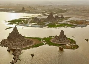 Lake Abbe , also known as Lake Abhe Bad , is a salt lake , lying on the Ethiopia - Djibouti border. It is one of a chain of six connected lakes, which also includes (from north to south) lakes Gargori, Laitali , Gummare , Bario and Afambo . The river Awash flows into the no-drain lake. The Lake Abbe is the center of the danakiil Depression. The Lac Abbe is considered one of the most visited areas of the earth. The water itself is known for its flamingo and egyptian goose . The nomade people have established a settlement near the lake's shore. Lake Abbe is known for its limestone chimneys, which reach heights of 50 m (160 ft) and from which steam spews forth. These carbonate chimneys are formed by the mixing of lake water and a deeper geothermal fluid. Flamingos can be found on the waters almost Every day. 