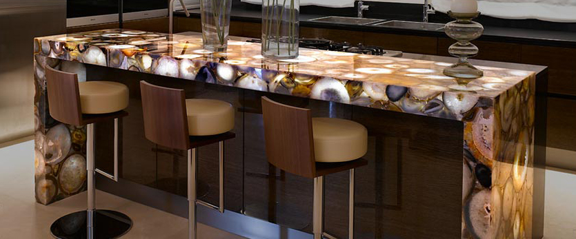 Kitchen island fabricated from precious agate with light source installed underneath the countertop