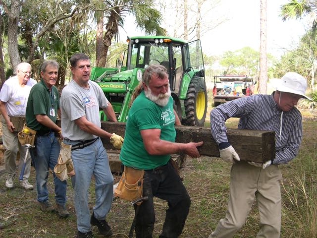 Friends of the Carlton volunteers with beam for pole barn