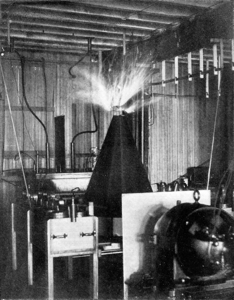 Fig. 15. — Tesla Coil for ascertaining and discharging the electricity of the earth. The streamers at top of coil are of purple hue, and in form resemble filaments of seaweed, the effect of mass being caused by prolonged exposure of flash-light negative.