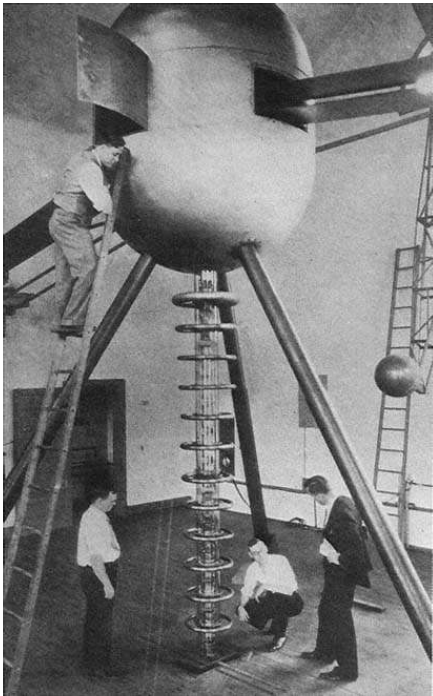 The Carnegie Institution's two-meter Van de Graaff; Dahl is on the ladder, Tuve in the suit. The business end of the discharge tube, deflecting magnets, and pumps are under the floor. Tuve, Hafstad, and Dahl, PR, 48 (1935), 322.