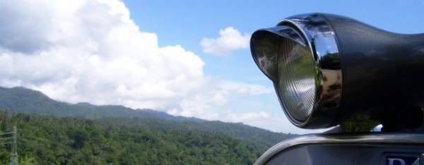 Vespa in the mountains with blue white sky