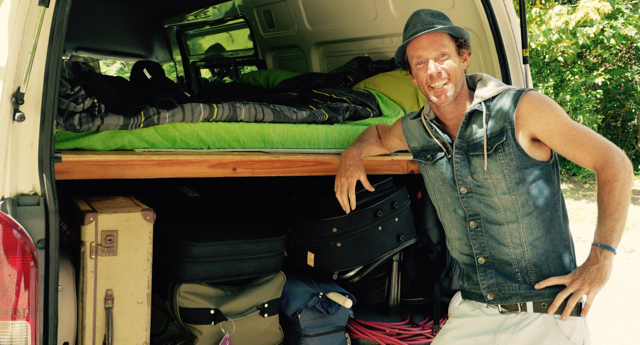Juzzie Smith with his touring van. Gear on the bottom, Bed on the top. Nice
