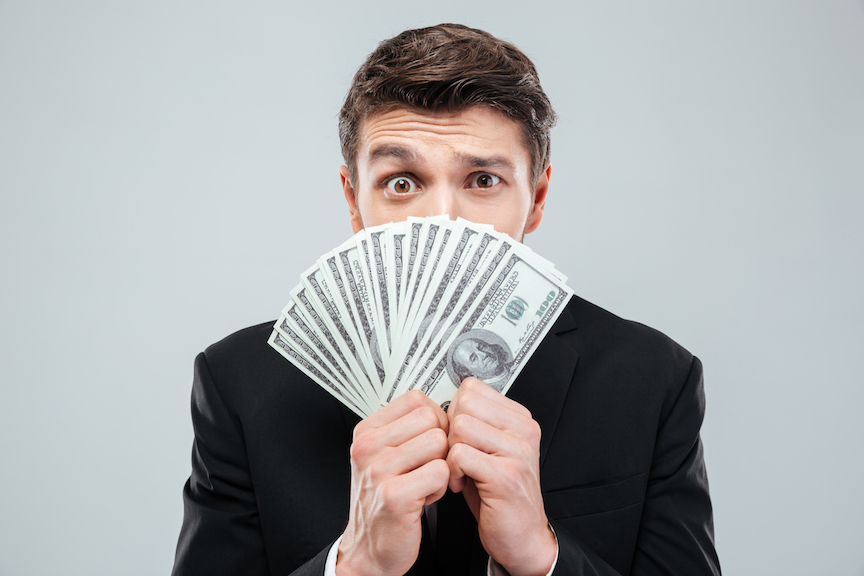 Man holding fanned out money confused about Registered Investment Advisors