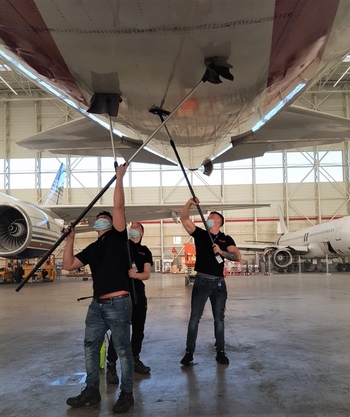 Men at work! Thoms Aviation team cleaning the fuselage of a B747-400F of operator CargoLogicAir parked in the hangar of MRO provider HiTech. 