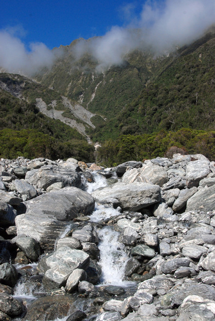 The massive schist riverbed of the Mill Stream. Schist was used as a 'dimension stone' because its bedding plains make it easy to split into building blocks. 