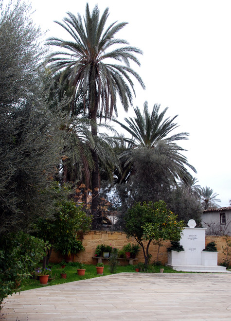 Agios Giorgios church yard with palms and clementine tree