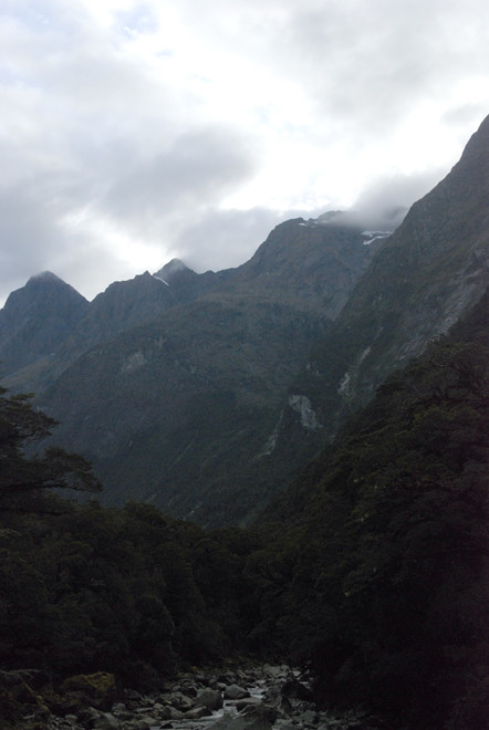 The massive ramparts of the Darran Mountains and Mt Tutoko (2,723m) from the historic suspension bridge over the Tutoko River on the Milford Raod.