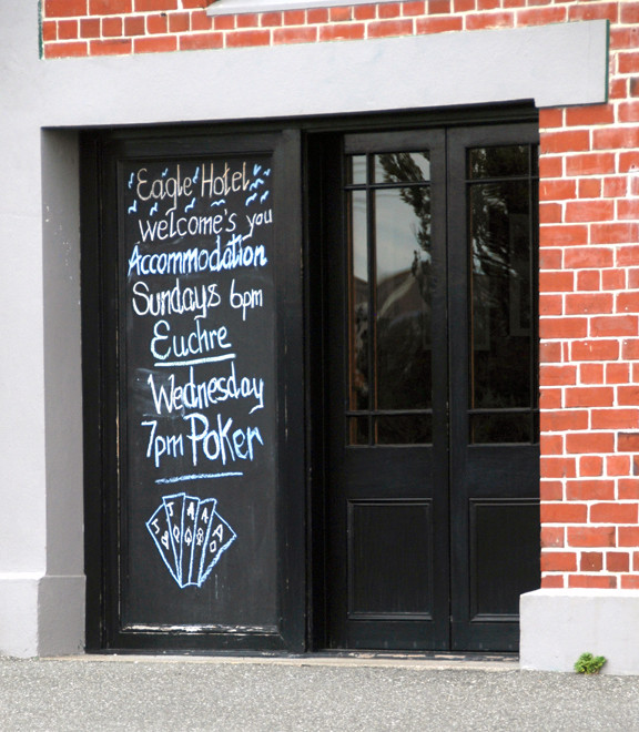 Sign advertising Euchre on Sunday evenings at the Eagle Hotel, Bluff, NZ.