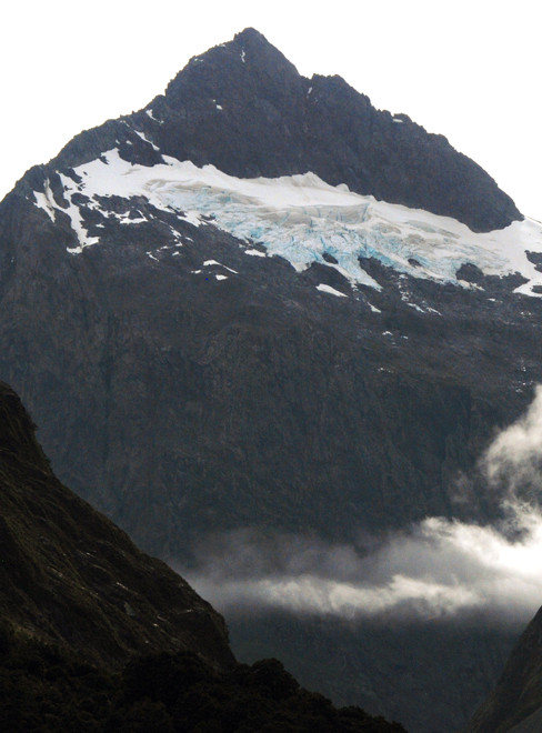 Mt Crosscut and hanging glacier above Cirque Creek on the Milford Road. The road is crossed by 40 avalanche paths.