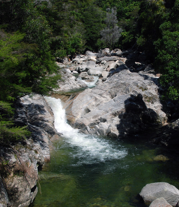 The crystal clear waters of the Wainui River that flows down from the marble table land at Canaan Downs on Takaka Hill. The rocks stripped bare of mosses and lichens by terrible floods.