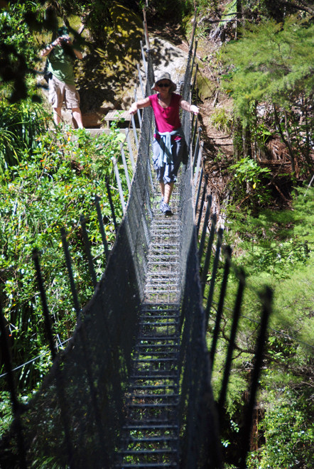 Karen takes on the swing bridge over the Wainui River in Golden Bay.