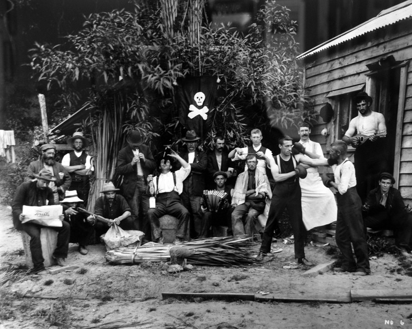 The recreation of flax mill workers in Mangarakau - see sheaf of flax on ground in fireground(c. 1890s Tyree Studio - Photo of photo in Community Centre) 