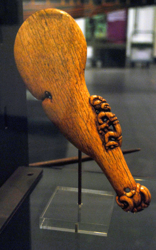 Maori bone club with figure and interrupted oval shape - a wahaika paraoa, mouth (waha) of the fish (ika) (Auckland Museum).