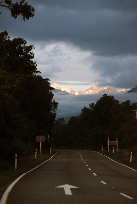 With darkness gathering in the lowland forest we began to catch glimpses of the Southern Alps through the low cloud.