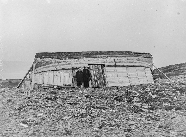 House for 8 people, two cows and a goat built from upturned wooden boat after the devastation of Gamvik in the Nazi's scorched earth policy in Finnmark, Norway (Norway National Archive Arkivreferanse: NTBs krigsarkiv i Riksarkivet (RA/PA-1209/U/Uj/L0214).