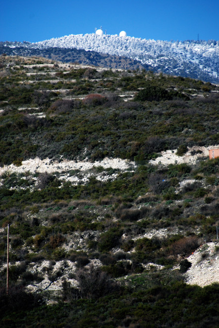 Looking up to Mount Olympus and military installations in the snow above Lofou, January 2013