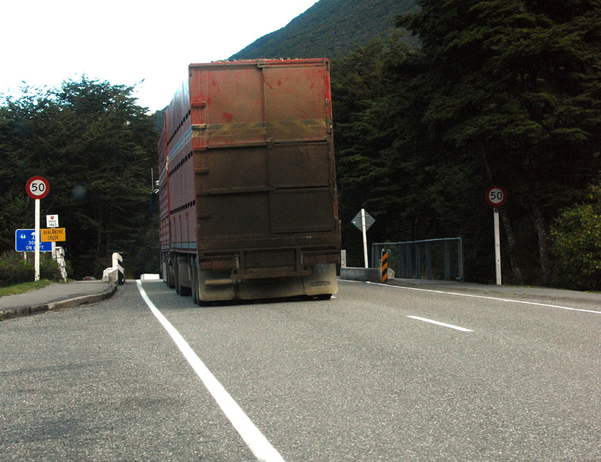 A big, dirty truck carrying stock to Christchurch crosses Avalanche Creek in Authur's Pass