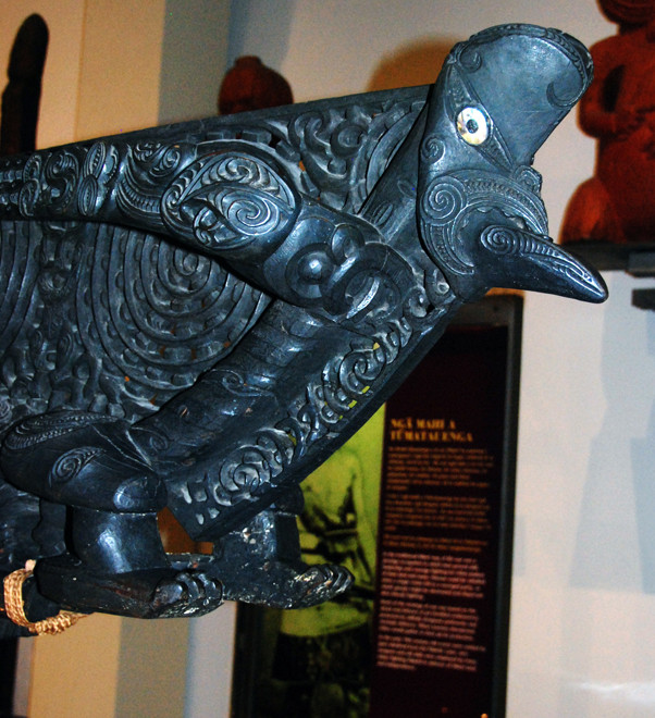 Side view of ornate carving on Maori Waka (ocean-going canoe)  prow in Auckland Museum. 