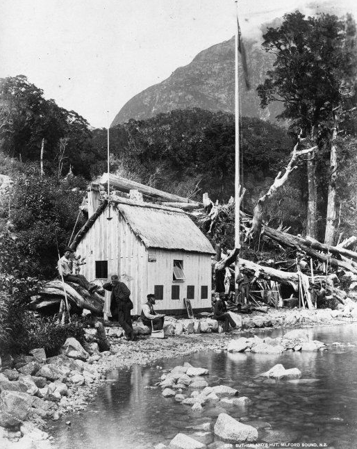 Five unidentified men outside Donald Sutherland's hut, the Esperance Chalet, Kennedy Station, Milford Sound, Southland. Taken by an unidentified photographer during the 1880s (Click for link)