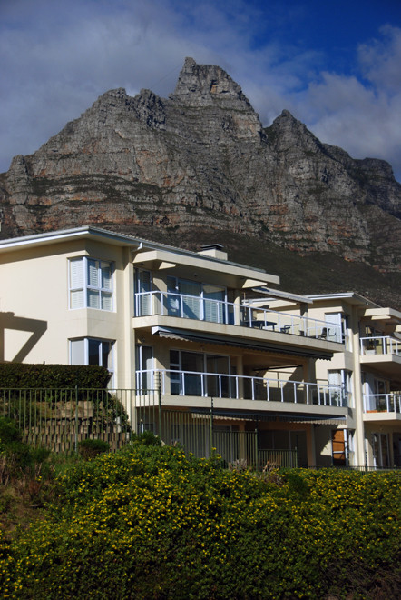 White paradise: upscale housing  in Camps Bay with one of the Twelve Apostles in the background