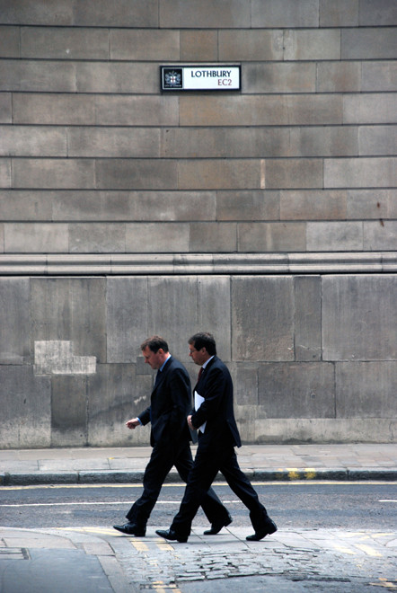 Two City men walking up Lothbury with the wall of the Bank of England in background. 