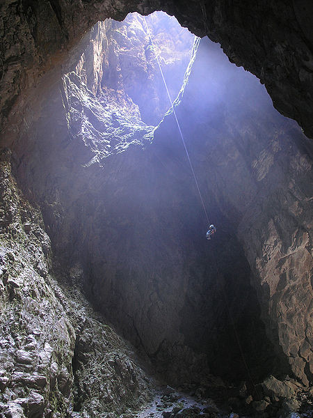 View of the entrance pit of Harwood Hole, New Zealand, taken from the bottom. It is 183 meters (about 600 feet) deep (Courtesy Dave Bunnell WikiCommons)