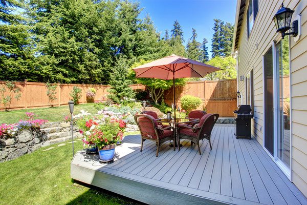 Extend your living space straight off the sliding glass patio doors with an expansive platform deck built to easily accommodate a barbecue, umbrella dining set and colorful planters. 