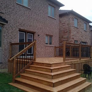 Create sections in a tight yard space with a fenced deck that offers deep steps cascading down to a second entertainment area in the lawn. 