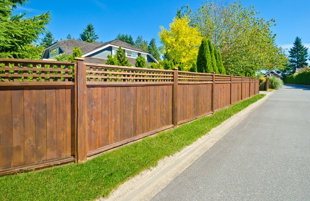 This street-lined fence offers grace and beauty on the inside and outside. Accent a cedar lap board fence with a square lattice top to increase the visual appeal.