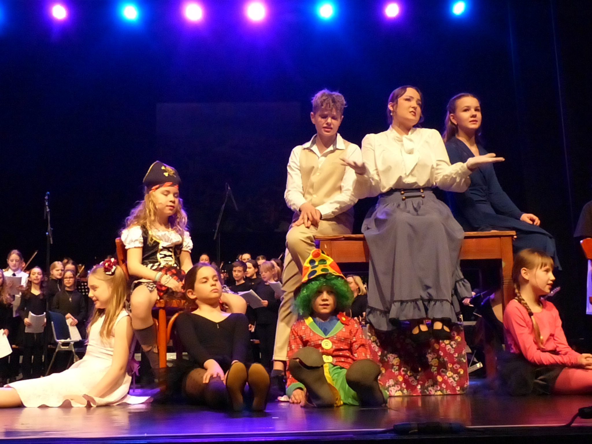 Mary Poppins sitzt mit den Kindern auf dem Tisch und lässt sie "aufräumen"...