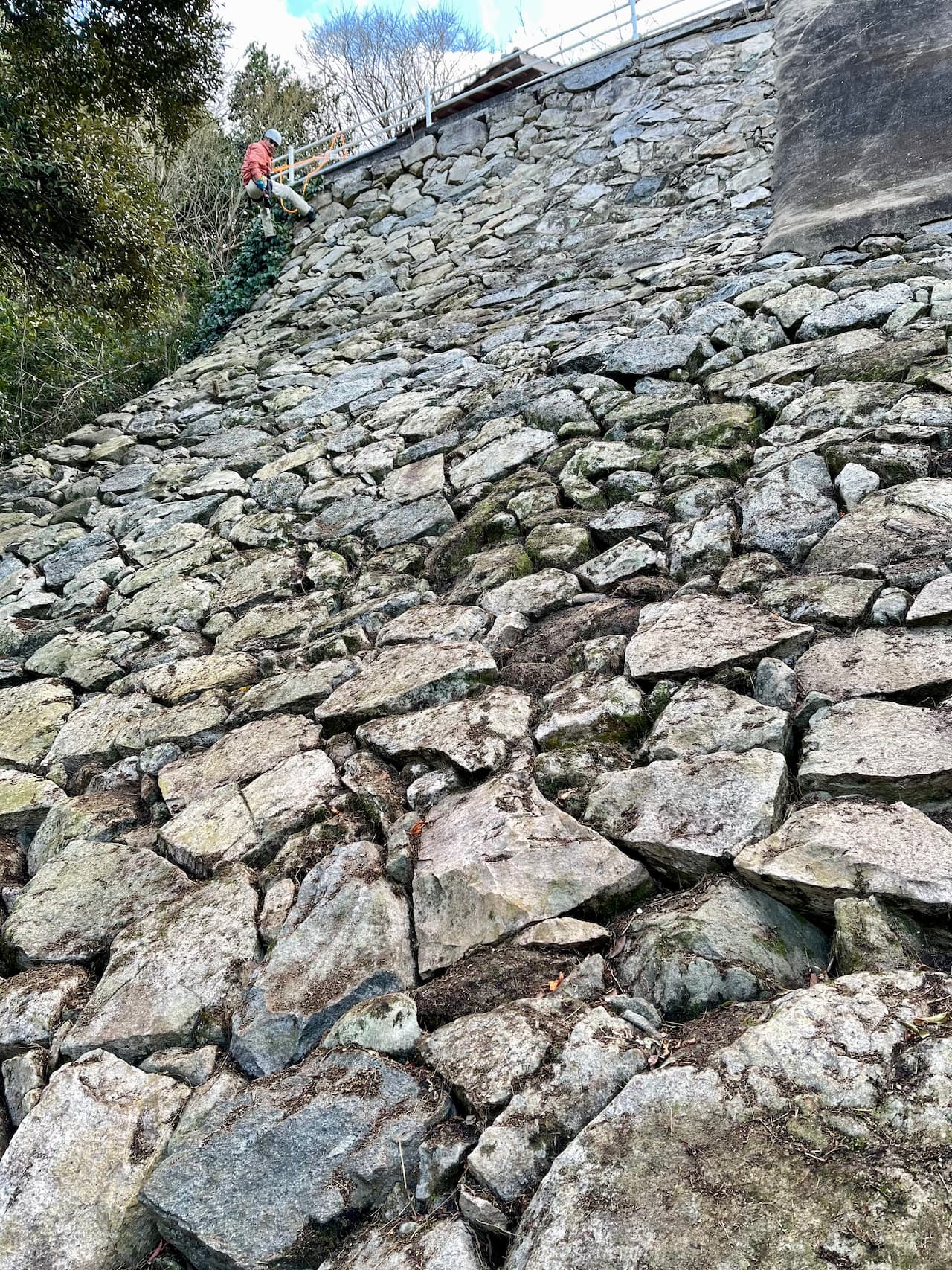 The 20-meter-high stone wall is depicted as part of the design of the good luck charm.