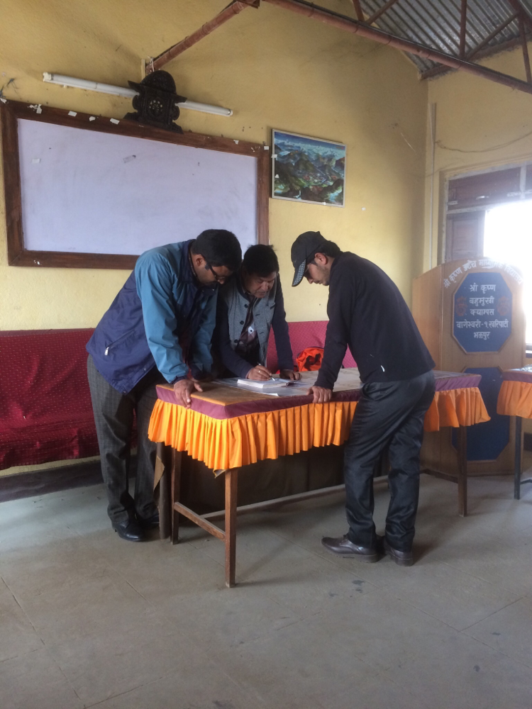 Rhadeshyam und Mohan sind mit einem Lehrer Listen am Organisieren!