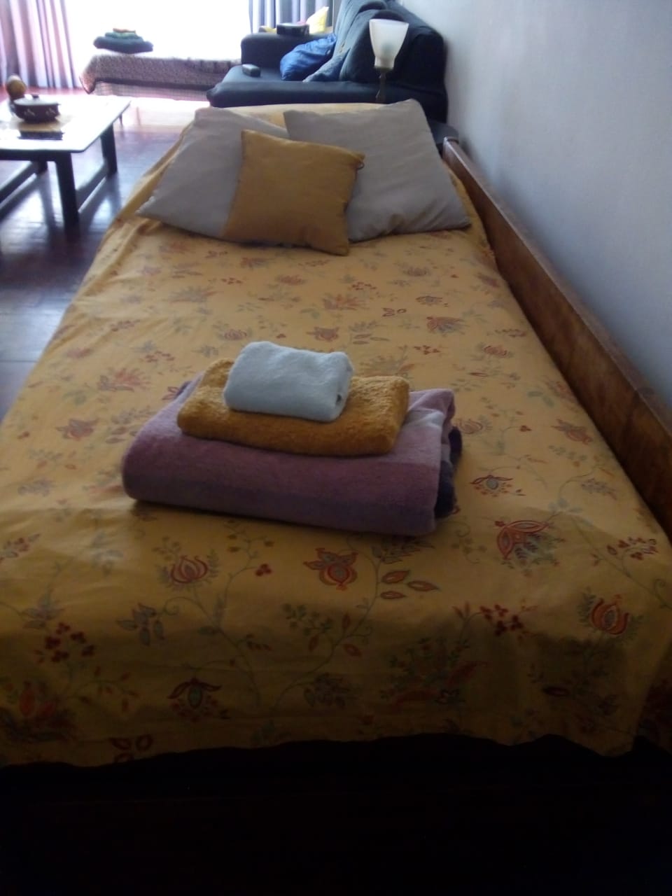 bed in the living room, ready for the guests