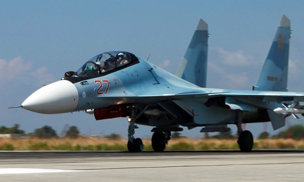 Un intercettore Su-30 in decollo da Latakia, da notare sulle derive i contrassegni della stella rossa e i codici occultati. / © Reuters