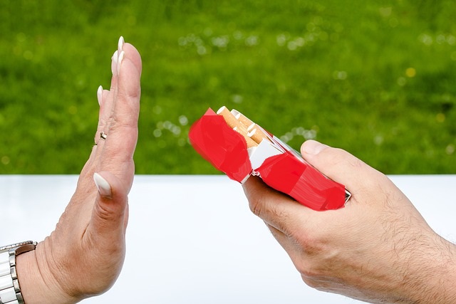 Hand einer Frau blockt eine angebotene Zigarette aus einer Zigarettenschachtel ab.