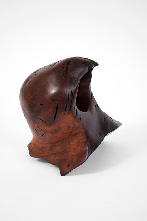 Abstract fine art wood sculpture featuring a smooth, dark reddish-brown polished finish with a large natural hollow opening, organic contours, and fine texture cracks on a clean white background.
