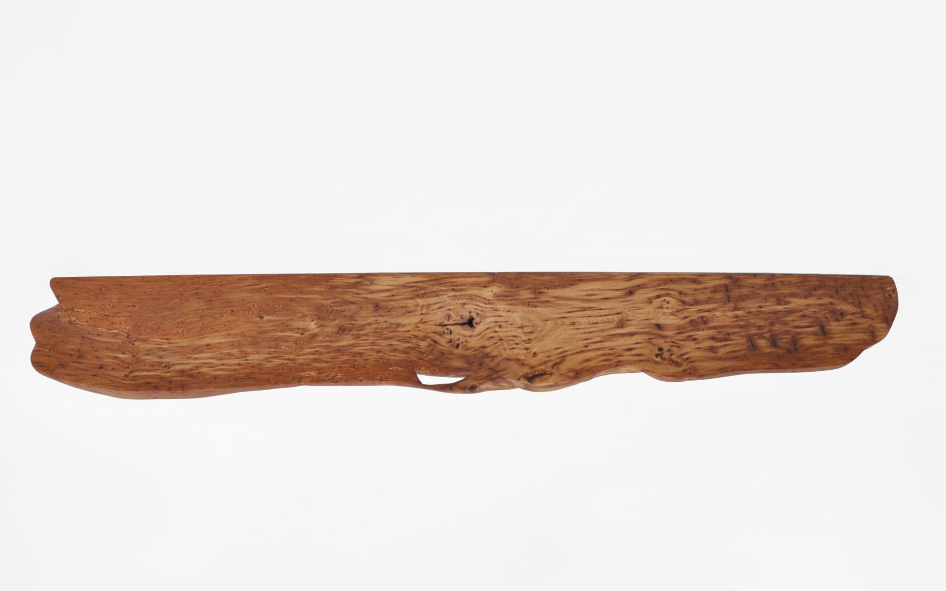 Grounding designer shelf W2505 in rustic oak – a singular floating artwork by Jörg Pietschmann, meticulously crafted to preserve organic topography, inviting the quiet breath of the ancient woods into sophisticated modern interiors.