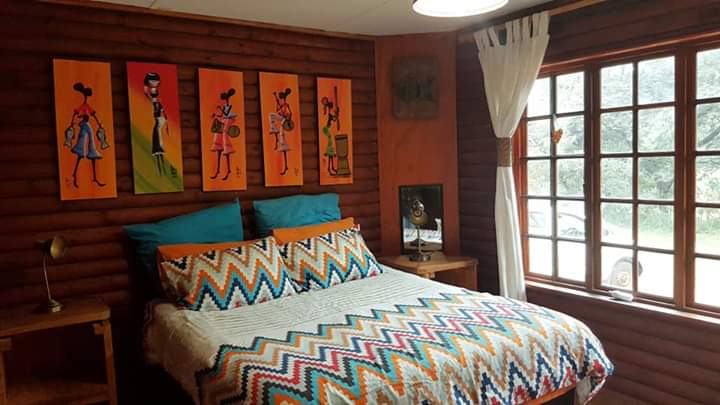 Main bedroom with queen-sized bed and an African flair