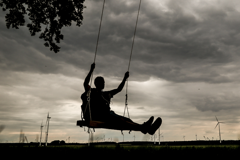 Dark rain clouds rolling in. Still, I enjoy some time on this massive swing. 